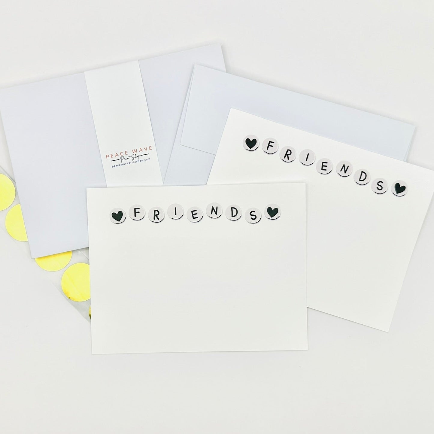 Flat stationery greeting cards with 'FRIENDS' text and heart symbols on a white background plus coordinating envelopes and gold sticker seals