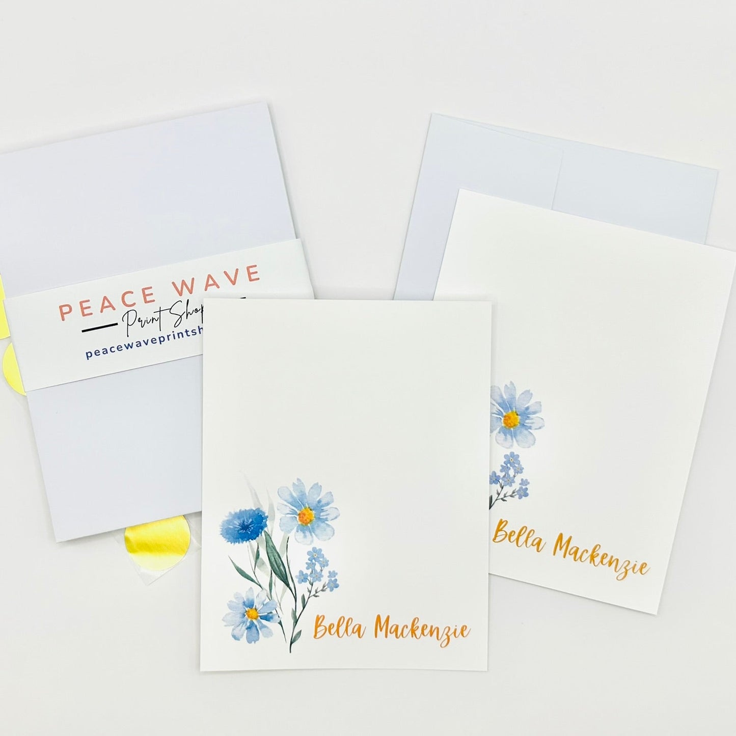 Set of personalized stationery greeting cards with floral designs and personalized names on a white background