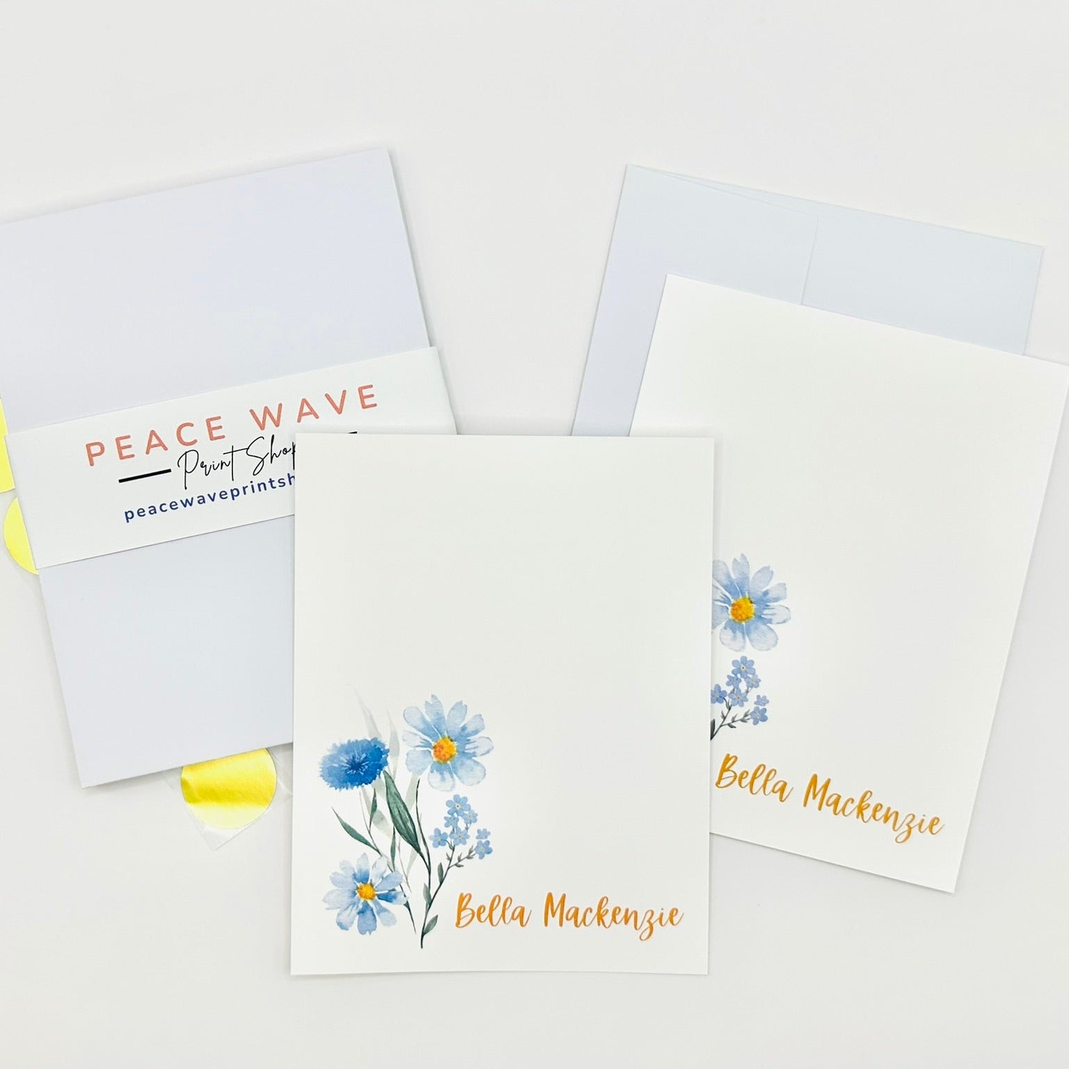 Set of personalized stationery greeting cards with floral designs and personalized names on a white background