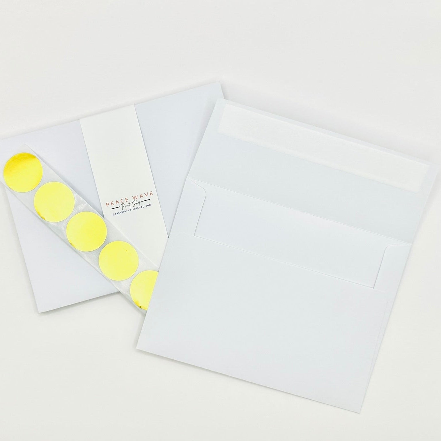 White envelopes with gold envelope seals on a white background