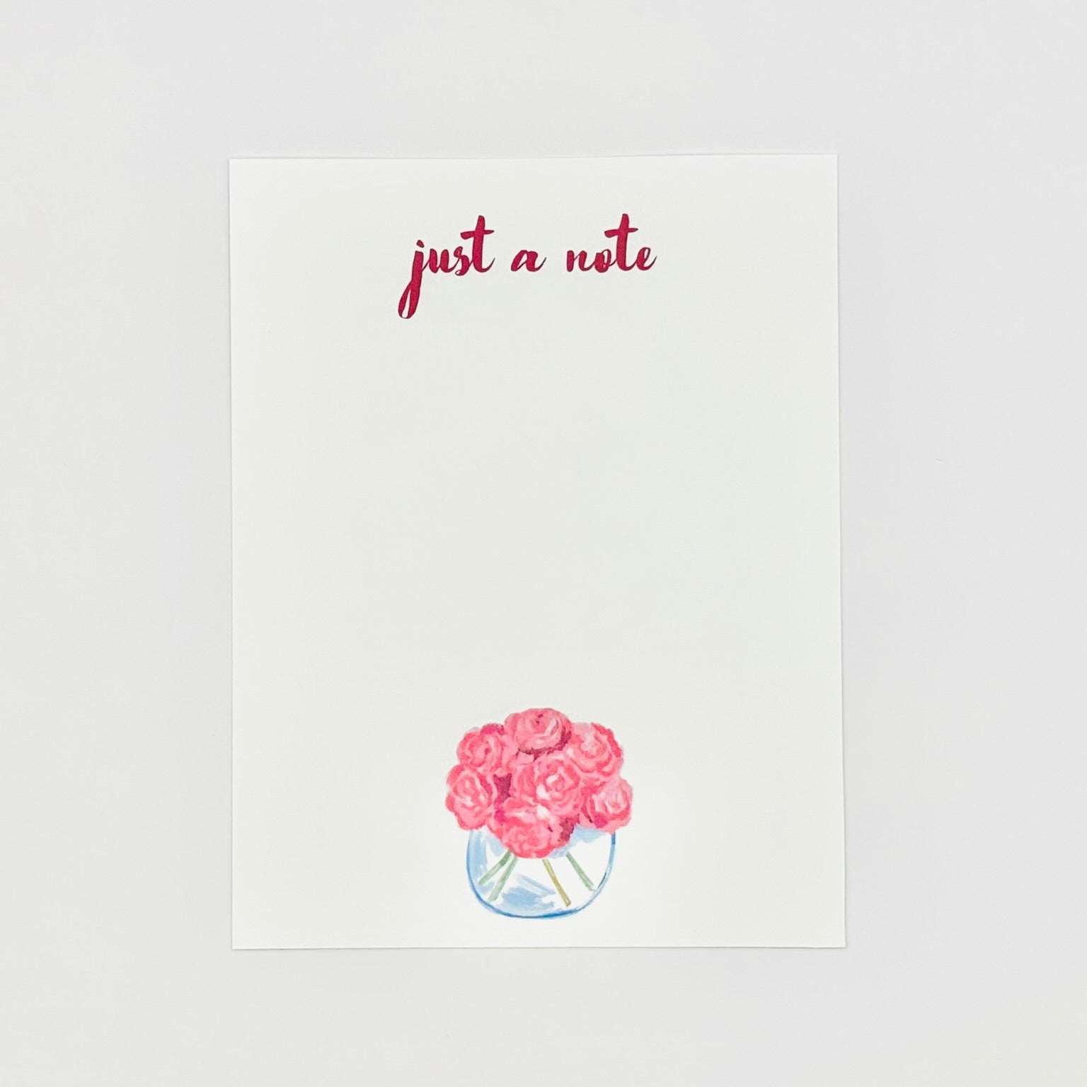 Stationery note card with pink roses and 'just a note' text on a white background