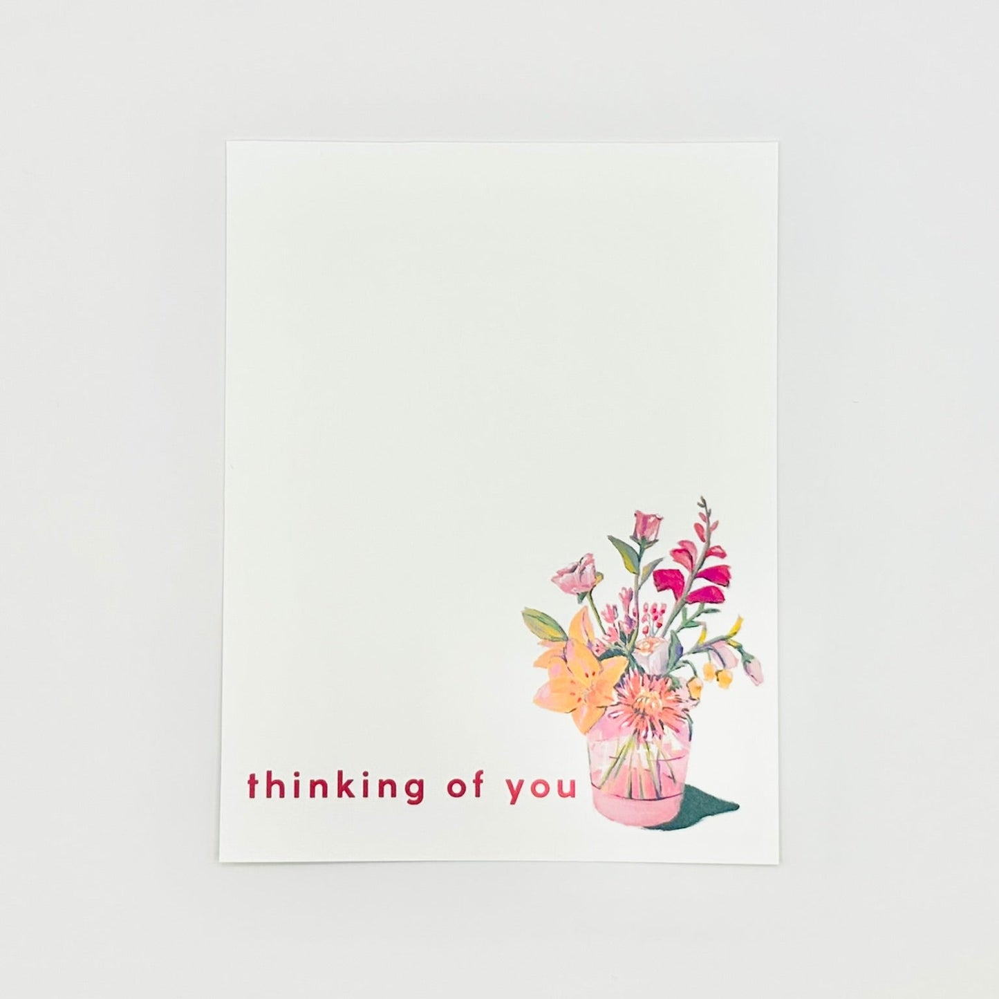 Flat stationery card in white with pink floral vase and 'thinking of you' printed in pink text on white background