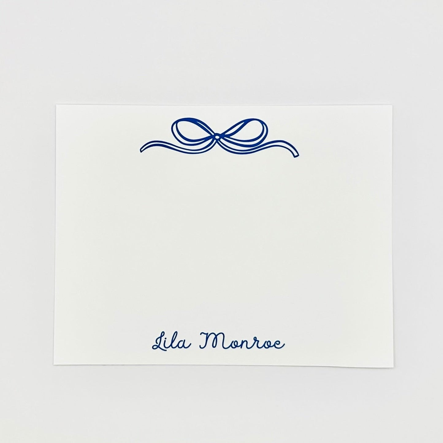 Personalized note card with decorative blue bow and name 'Lila Monroe' on a white background