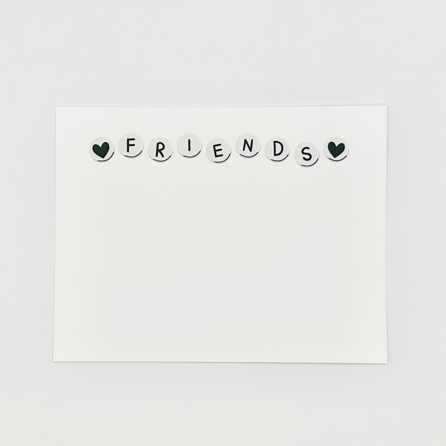 White card with 'FRIENDS' text on a light gray background