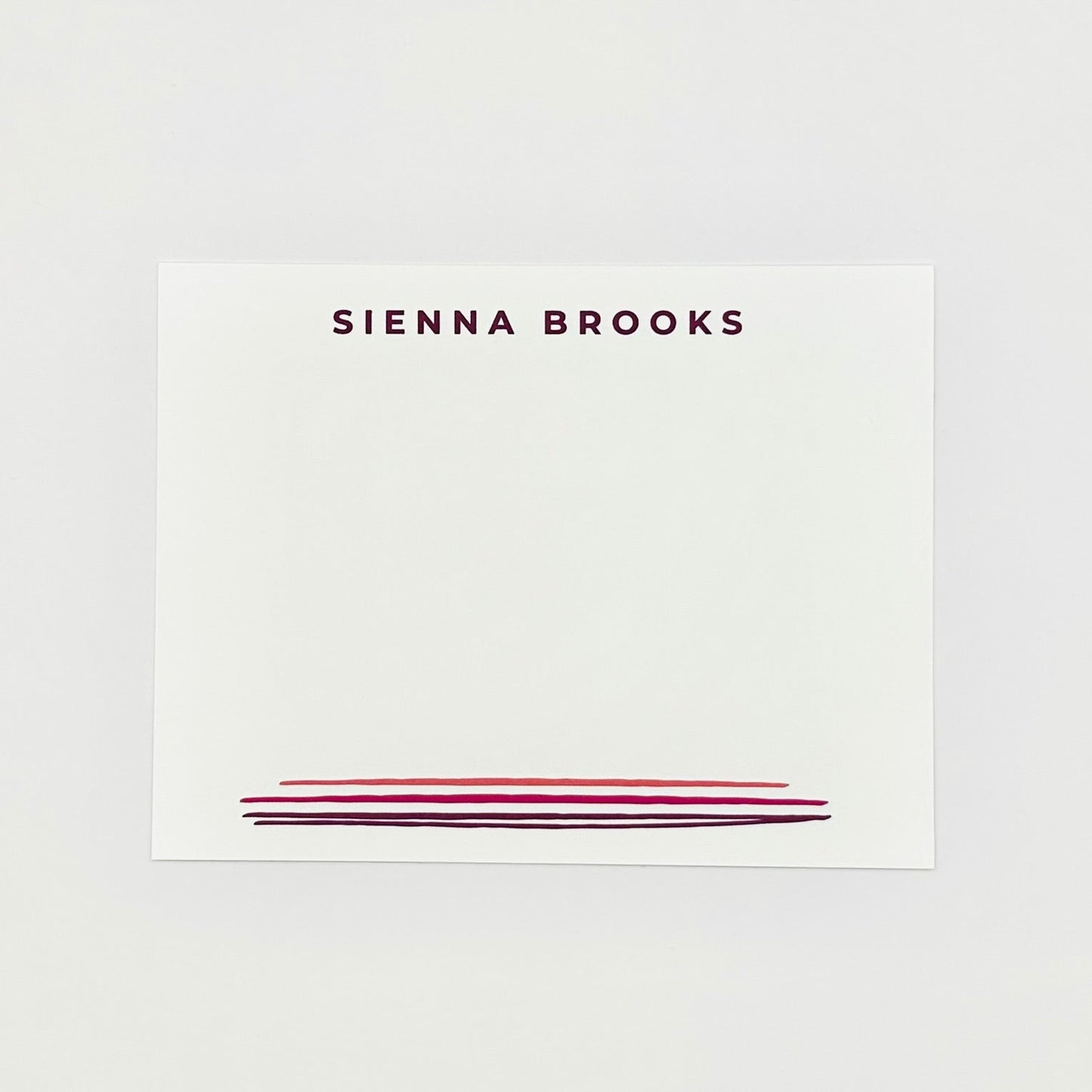 Personalized name card with 'SIENNA BROOKS' printed on a white background