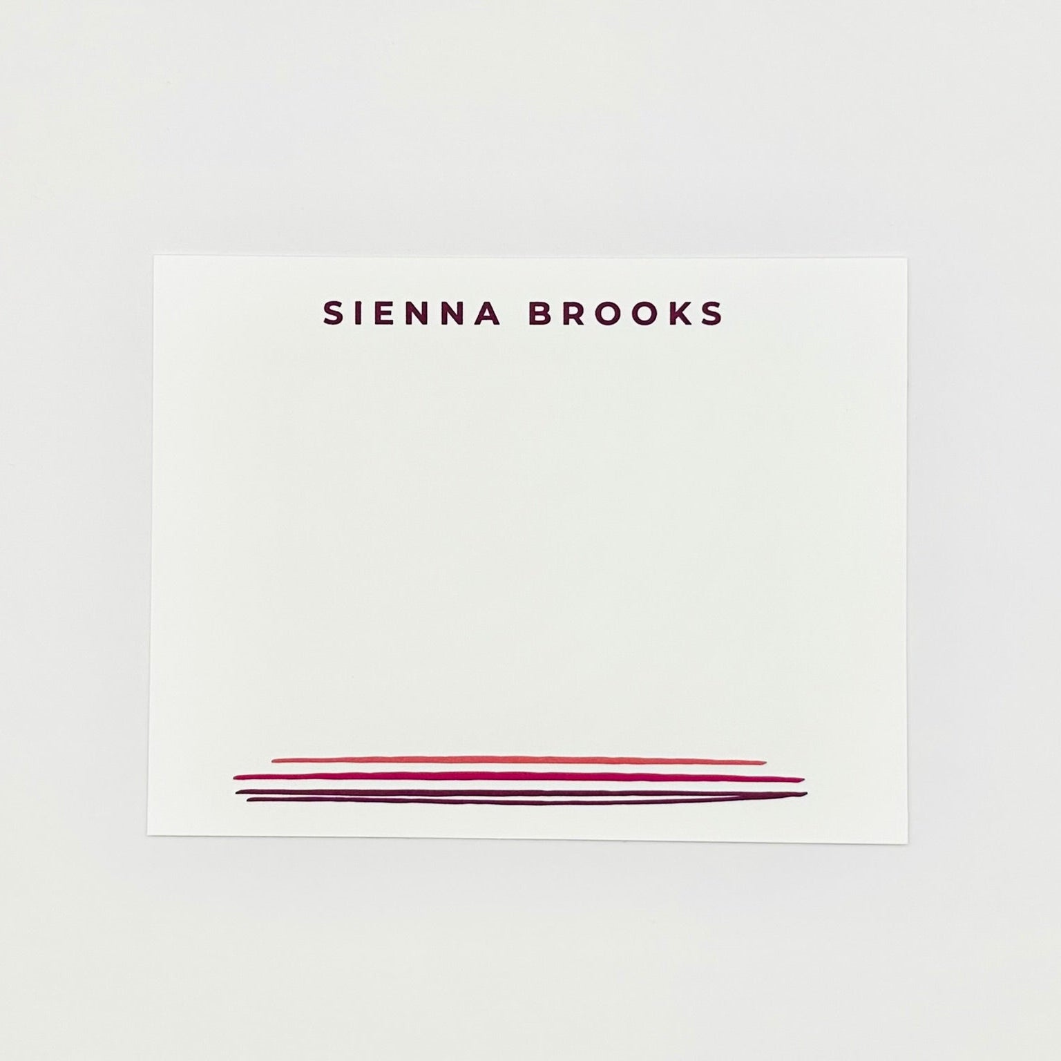 Personalized name card with 'SIENNA BROOKS' printed on a white background