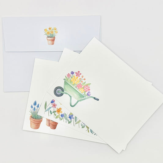 Stationery set greeting cards with gardening-themed floral illustration on a white background and coordinating envelopes