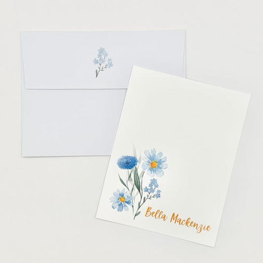 Personalized flat stationery greeting card with blue floral design and envelope on a white background