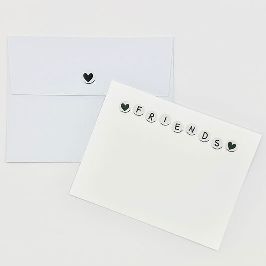 Stationery white card with 'FRIENDS' text and heart symbols on a white background